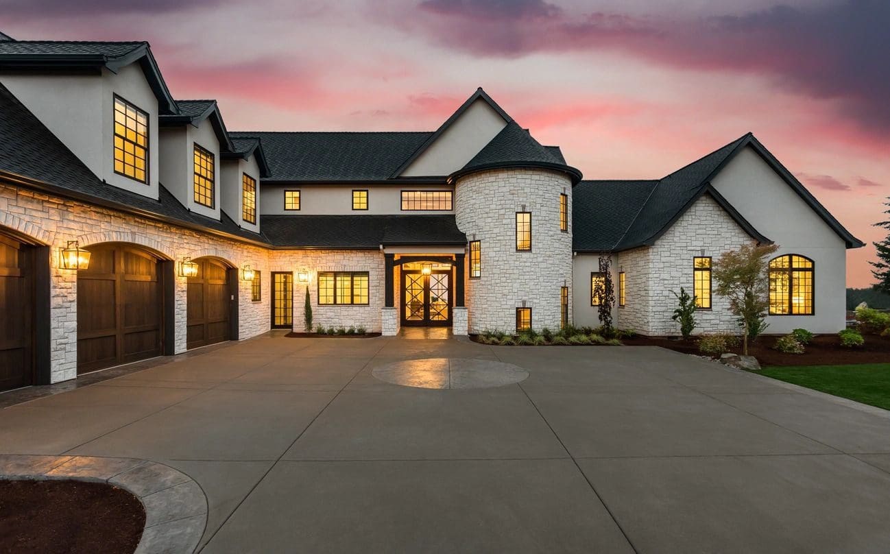 Large home with stone exterior and driveway.